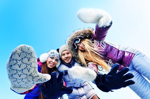 People wrapped up warm on a winter day, illustrating why to keep waxing through winter to prep for summer